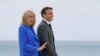 French President Emmanuel Macron and his wife Brigitte Macron arrive to pose for photos with British Prime Minister Boris Johnson and his wife Carrie Johnson at the G-7 summit, in Carbis Bay, Cornwall, Britain June 11, 2021.